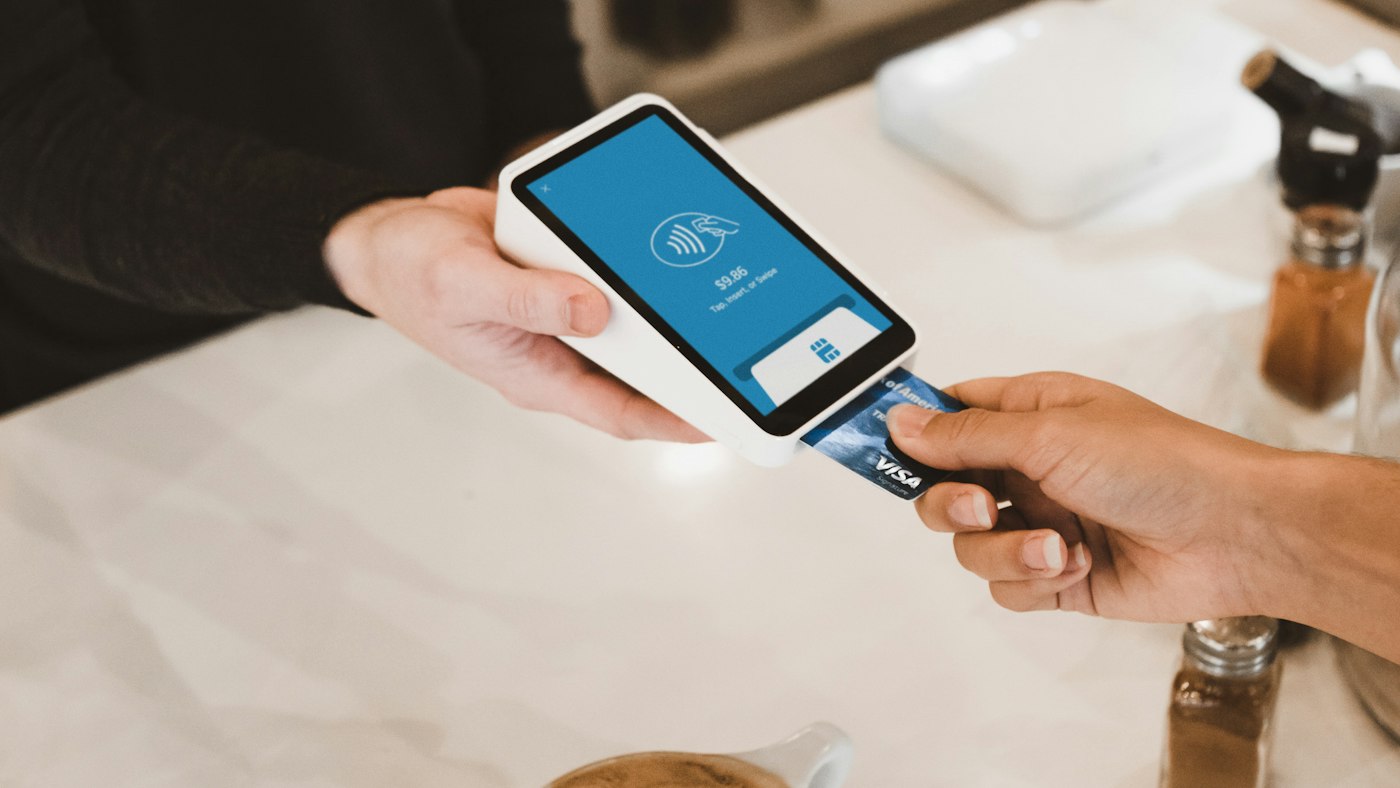 A payment terminal held out at a counter