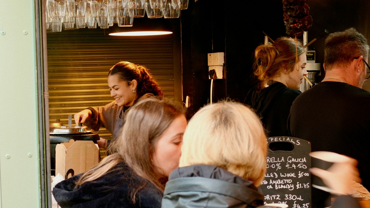 Regulars talking over drinks in a busy café