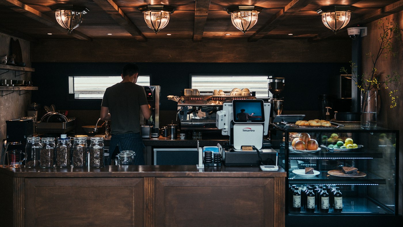 A barista working at the coffee machine in a café