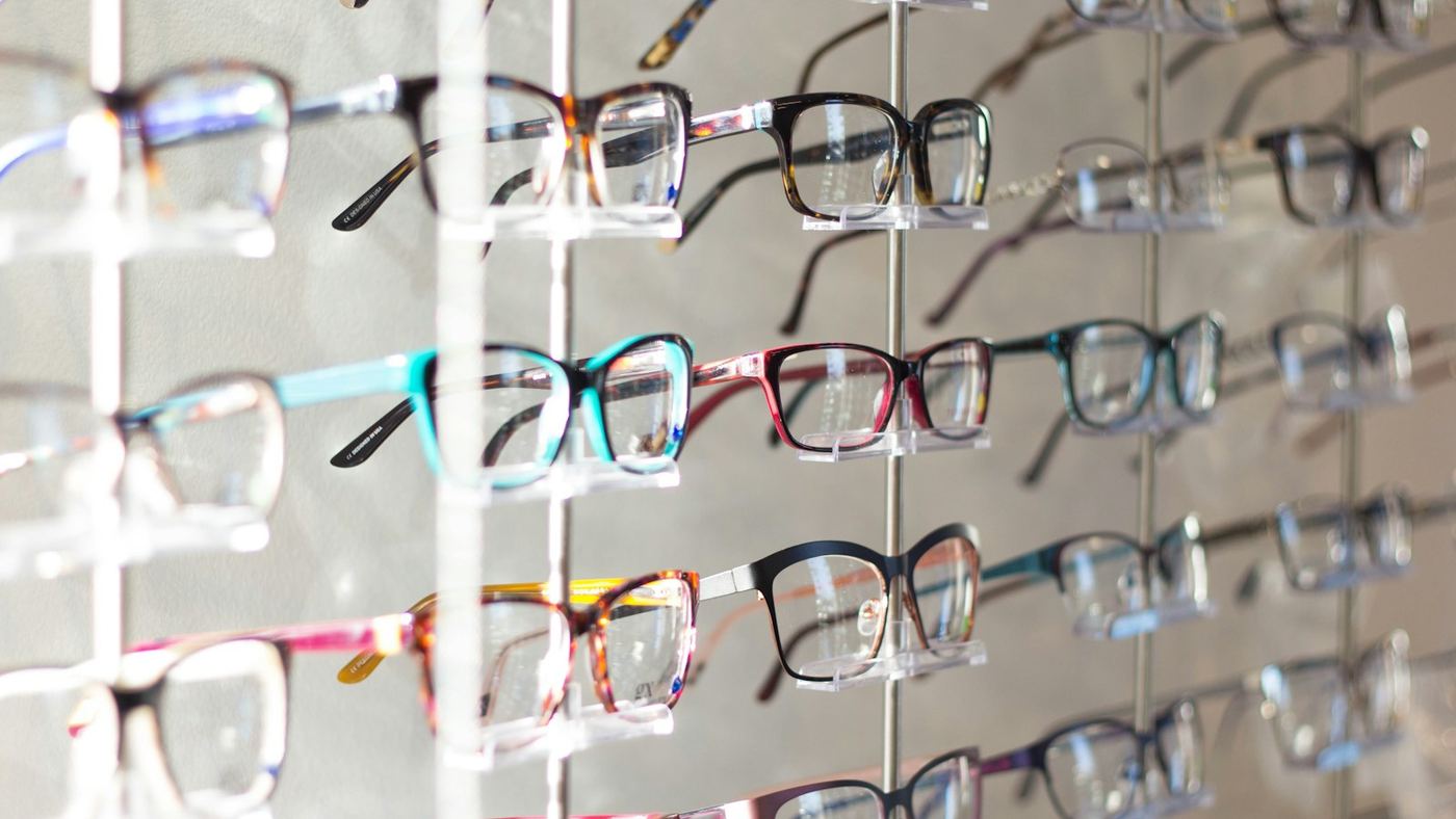 A wall display of spectacle frames in an opticians’ practice